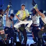 A music band singing and dancing on a stage